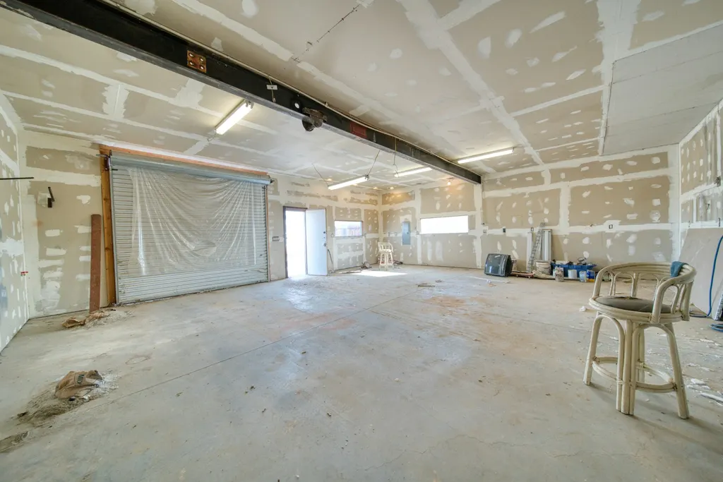 Interior renovation with unfinished drywall seams across the walls and ceiling
